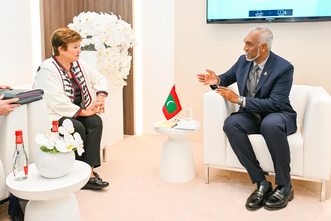 IMF Managing Director Kristalina Georgieva and President Mohamed Muizzu seated in white armchairs, with a small Maldivian flag on the table between them.